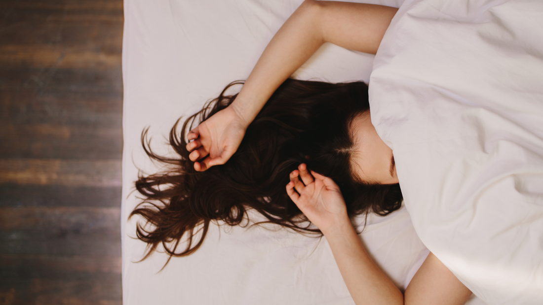 "Image of a young woman peacefully sleeping in a cozy, dimly-lit bedroom, suggesting a restful night's sleep. The scene conveys tranquility and relaxation, symbolizing the effectiveness of the 'Twilight' sleep supplement from Peach Perfect."