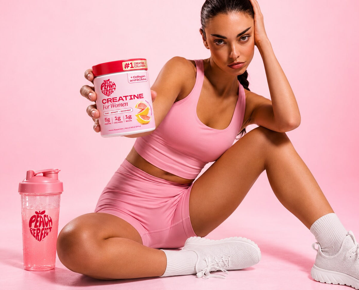 Woman in pink activewear holding a jar of Peach Perfect Creatine for Women in Pink Lemonade